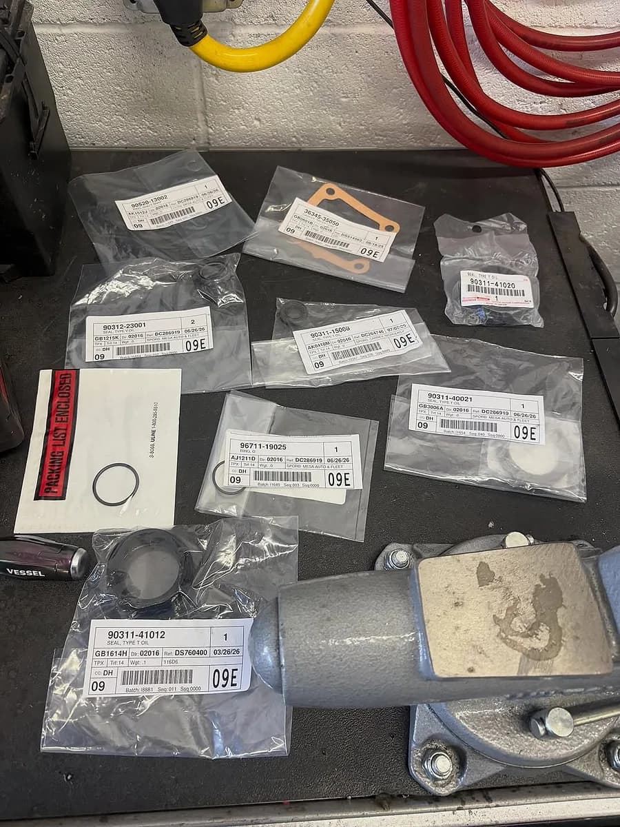 Genuine OEM Toyota parts laid out for a repair at Mesa Auto & Fleet